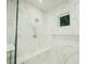 Spacious shower with marble tile and built-in seat at 4160 W Ford Ave, Las Vegas, NV 89139