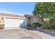 House exterior featuring a two-car garage and well-maintained landscaping at 6657 Diamond Care Dr, Las Vegas, NV 89122