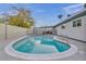 Backyard pool, complemented by a well-maintained yard, trees, and secure fencing at 713 Antelope Way, Las Vegas, NV 89145