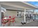 Outdoor patio area with a dining table, bar stools and white patio cover at 713 Antelope Way, Las Vegas, NV 89145
