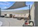 Comfortable poolside seating with shade sail and well-maintained landscaping for outdoor relaxation at 713 Antelope Way, Las Vegas, NV 89145