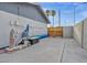Side yard of a home with necessary equipment, a storage area, and a pathway leading to the backyard at 713 Antelope Way, Las Vegas, NV 89145