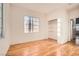 Well-lit bedroom with wood floors and built-in shelving at 7728 White Flower Ct, Las Vegas, NV 89131