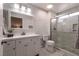 Well-lit bathroom with a white vanity, toilet, and glass-enclosed shower at 8516 Spyrun Dr, Las Vegas, NV 89134