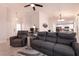 Inviting living room featuring a plush gray sofa, chair, and bright, neutral paint at 8516 Spyrun Dr, Las Vegas, NV 89134