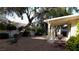 Backyard featuring mature trees, fountain, and covered patio, offering serenity at 9728 Echo Hills Dr, Las Vegas, NV 89134