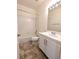 Bright bathroom featuring a tiled shower-tub, ceramic tile floor, and white vanity at 9728 Echo Hills Dr, Las Vegas, NV 89134