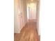 Hallway with wood floors, white walls and cabinetry, and bright interior lighting at 9728 Echo Hills Dr, Las Vegas, NV 89134