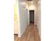 Hallway with wood floors, white walls and cabinetry, connecting various rooms at 9728 Echo Hills Dr, Las Vegas, NV 89134