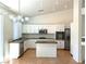 Bright kitchen featuring white cabinets, granite countertops, and stainless steel appliances at 9728 Echo Hills Dr, Las Vegas, NV 89134