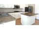 Modern kitchen with granite countertops, stainless steel appliances, and a center island at 9728 Echo Hills Dr, Las Vegas, NV 89134