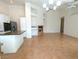 Spacious living room with tile floors, fireplace, and a view into the modern kitchen at 9728 Echo Hills Dr, Las Vegas, NV 89134
