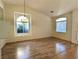Bright living room with wood flooring, arched windows and modern light fixtures at 9728 Echo Hills Dr, Las Vegas, NV 89134