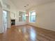 Bright living room with wood floors, high ceilings, fireplace, and modern light fixture at 9728 Echo Hills Dr, Las Vegas, NV 89134