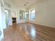 Bright living room featuring wood floors, a cozy fireplace and arched windows at 9728 Echo Hills Dr, Las Vegas, NV 89134