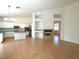 Spacious living room with tile flooring and a fireplace, flowing seamlessly into the kitchen at 9728 Echo Hills Dr, Las Vegas, NV 89134