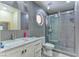 Modern bathroom with gray tile, a marble vanity, and a glass shower at 1818 Waldman Ave, Las Vegas, NV 89102