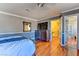 Bright bedroom with hardwood floors and access to a hallway and bathroom at 1818 Waldman Ave, Las Vegas, NV 89102