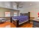 Spacious bedroom with hardwood floors, a large bed, and a ceiling fan at 1818 Waldman Ave, Las Vegas, NV 89102