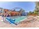 Inviting backyard pool with brick patio and arched metal cover at 1818 Waldman Ave, Las Vegas, NV 89102