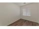 Simple bedroom featuring hardwood floors and a single window for natural light and neutral wall paint at 6485 Arrow Cottage Ct, Las Vegas, NV 89130