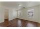 Bright bedroom with hardwood floors, two windows, and a walk-in closet for ample storage space at 6485 Arrow Cottage Ct, Las Vegas, NV 89130