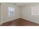 Cozy bedroom featuring hardwood floors and a window with natural light and neutral wall paint at 6485 Arrow Cottage Ct, Las Vegas, NV 89130