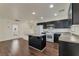 Modern kitchen featuring dark wood floors and a gray island, offering seamless flow at 6485 Arrow Cottage Ct, Las Vegas, NV 89130