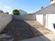 Unlandscaped backyard with block wall and gate at 1113 Cloudy Day Dr, Henderson, NV 89074