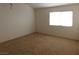 Simple bedroom with carpeted floor and large window at 1113 Cloudy Day Dr, Henderson, NV 89074