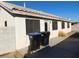 Rear house exterior view with patio and trash cans at 1113 Cloudy Day Dr, Henderson, NV 89074