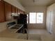 Kitchen with wood cabinets, gas range and refrigerator at 1113 Cloudy Day Dr, Henderson, NV 89074