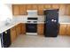 Galley style kitchen with wood cabinets and appliances at 1113 Cloudy Day Dr, Henderson, NV 89074