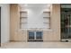 Sophisticated bar area showcases custom cabinets, a marble countertop, mini-fridges, and a glass wine cellar at 19 Rue Grimaldi Way, Henderson, NV 89011