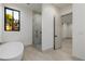 Modern bathroom featuring a soaking tub and glass-enclosed shower at 19 Rue Grimaldi Way, Henderson, NV 89011