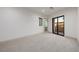 Bedroom with neutral carpet, baseboards, and private balcony access at 19 Rue Grimaldi Way, Henderson, NV 89011