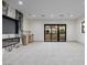 Well-lit bonus room featuring a sleek fireplace wall, wet bar, and sliding doors to an outdoor space at 19 Rue Grimaldi Way, Henderson, NV 89011