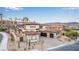 An aerial front view showing the home with lush landscaping, paver driveway, and a tile roof at 19 Rue Grimaldi Way, Henderson, NV 89011