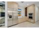 Modern kitchen features stainless steel refrigerator, built-in oven, and sleek wood cabinetry at 19 Rue Grimaldi Way, Henderson, NV 89011