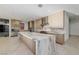 Modern kitchen features a large marble island, stainless steel appliances, and custom wood cabinetry at 19 Rue Grimaldi Way, Henderson, NV 89011