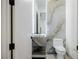 Stylish powder room featuring marble accent wall and modern sink with an integrated marble base at 19 Rue Grimaldi Way, Henderson, NV 89011