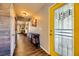 Bright entryway with yellow door and wood-look floors at 3698 Rawhide Ct, Las Vegas, NV 89120