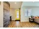 Inviting entryway with yellow door, wood-look floors, and a rustic accent wall at 3698 Rawhide Ct, Las Vegas, NV 89120