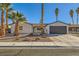 Remodeled single-story home with a landscaped front yard and new garage door at 3698 Rawhide Ct, Las Vegas, NV 89120