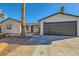 Single story home with a walkway leading to the front door and a dark brown garage door at 3698 Rawhide Ct, Las Vegas, NV 89120