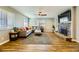 Living room with hardwood floors, a stone fireplace, and a large sectional sofa at 3698 Rawhide Ct, Las Vegas, NV 89120