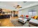 Open living room with L-shaped sectional sofa, coffee table, and hardwood floors at 3698 Rawhide Ct, Las Vegas, NV 89120