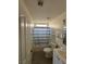 Full bathroom with vanity, toilet, shower, and blue-striped shower curtain at 4900 Quinlan Ave, Las Vegas, NV 89130