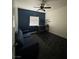 Cozy bedroom with a dark blue accent wall, ceiling fan, and vinyl floors at 4900 Quinlan Ave, Las Vegas, NV 89130