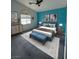 Bedroom with blue accent wall, ceiling fan, and a bench at 4900 Quinlan Ave, Las Vegas, NV 89130